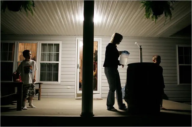Jennifer Hall-Massey relies on drinking water that is brought in by truck and stored in barrels on her porch near Charleston, W.Va.
